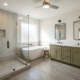 3f - J.E.P. Contracting | J.E.P. Contracting Modern bathroom with a glass-enclosed shower, freestanding tub, and an olive-green double vanity with two sinks and mirrors | J.E.P. Contracting