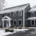 Snowy two-story blue house with white trim and a front porch. | J.E.P. Contracting