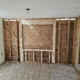 20260501_165245 - J.E.P. Contracting | J.E.P. Contracting Room under renovation with exposed wooden studs, OSB wall sheathing, and a ceiling electrical hole with hanging wires. | J.E.P. Contracting